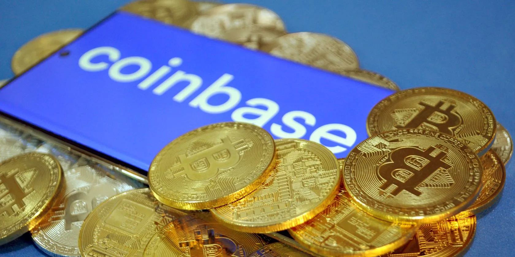 Logo Coinbase với các đồng Bitcoin bao quanh, biểu tượng sàn giao dịch tiền điện tử