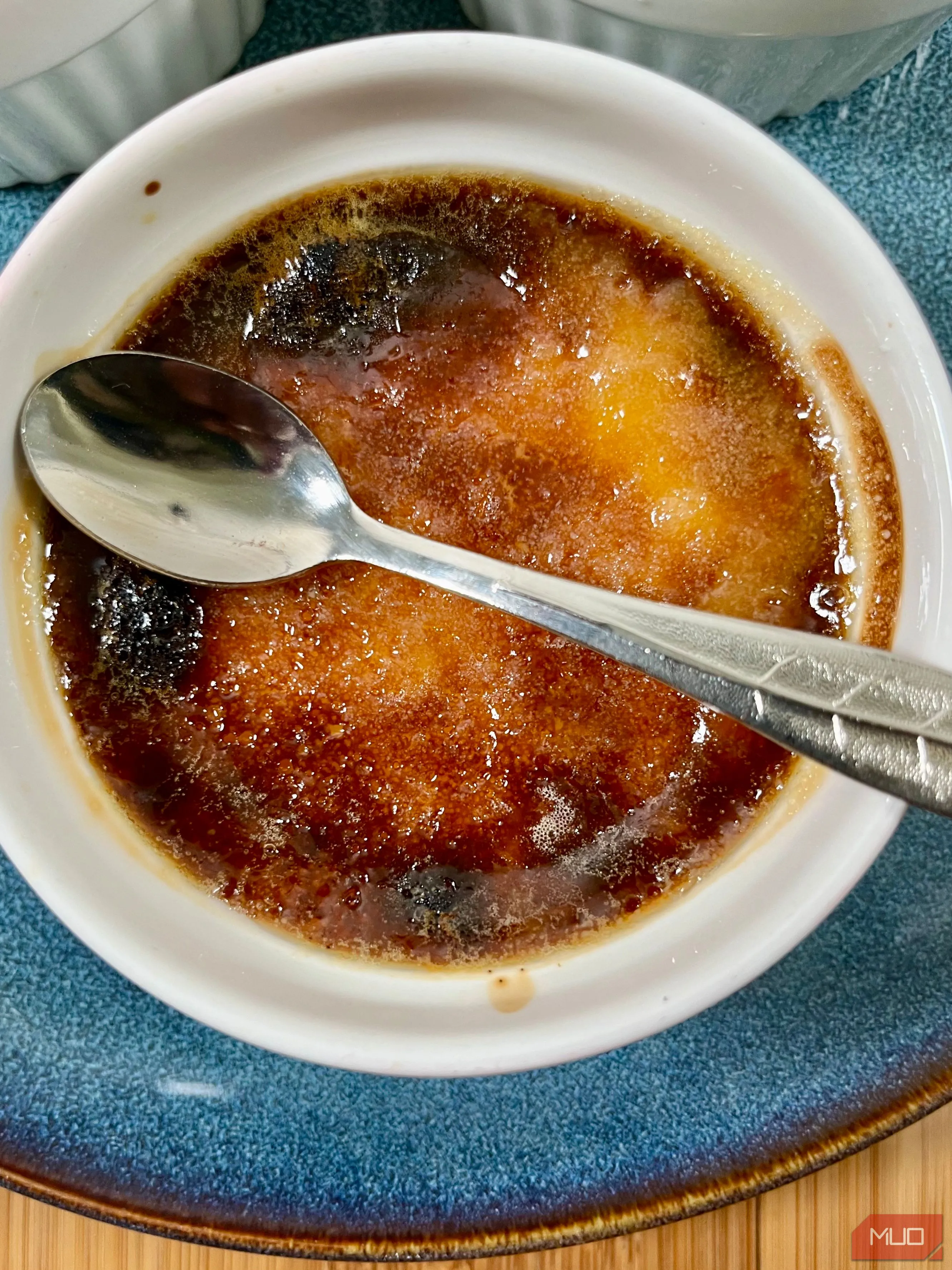 Món kem cháy (Crème brûlée) được chụp với ánh sáng tự nhiên hài hòa, làm nổi bật lớp đường caramel giòn.