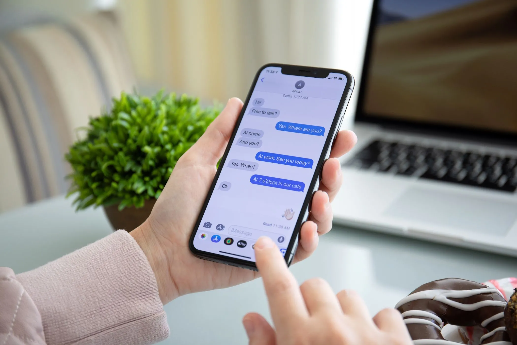 Một người phụ nữ đang sử dụng iMessage trên iPhone, thể hiện giới hạn tương thích tin nhắn giữa các hệ điều hành khác nhau.