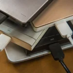 Nhiều ổ cứng di động và SSD đặt trên laptop thể hiện giải pháp lưu trữ đa dạng